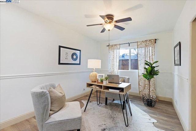 home office featuring wood-type flooring and ceiling fan