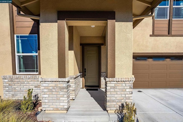 doorway to property with a garage