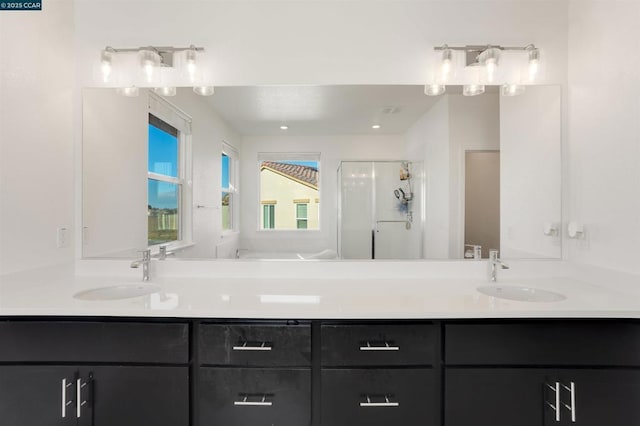 bathroom featuring walk in shower and vanity