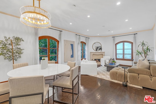 dining space with ornamental molding, dark hardwood / wood-style floors, an inviting chandelier, and french doors