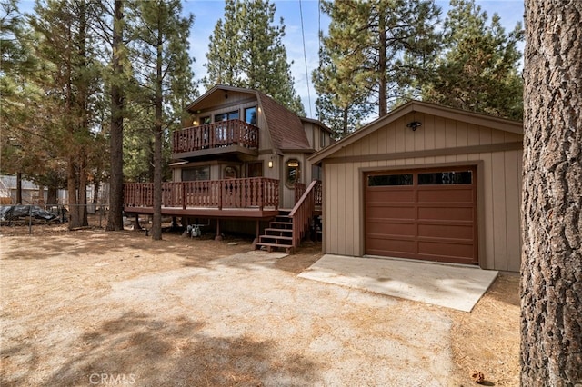 view of front of home with a garage, an outdoor structure, and a deck