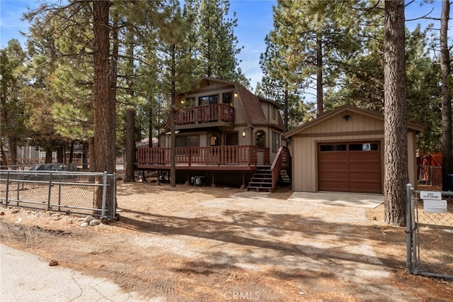 view of front of home featuring an outbuilding, a garage, and a wooden deck