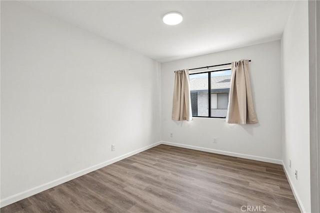 unfurnished room with hardwood / wood-style flooring