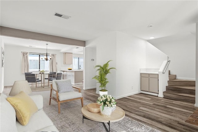 living room featuring an inviting chandelier and hardwood / wood-style flooring