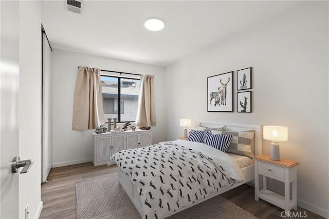 bedroom with hardwood / wood-style floors