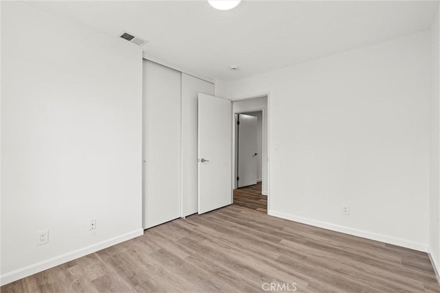 spare room featuring light hardwood / wood-style flooring