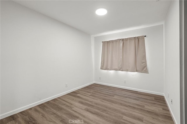 spare room featuring hardwood / wood-style floors