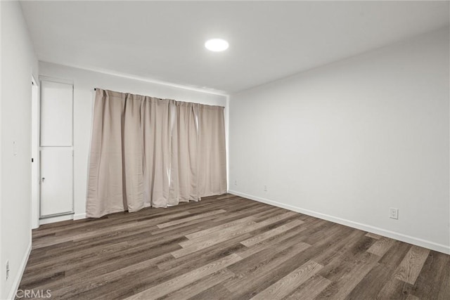 spare room with dark hardwood / wood-style floors