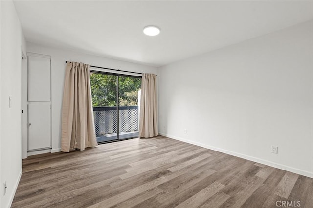 unfurnished room with light hardwood / wood-style flooring