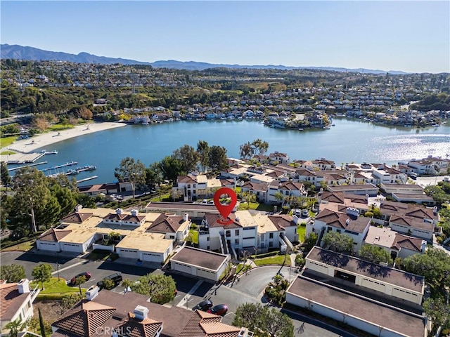 drone / aerial view featuring a water and mountain view