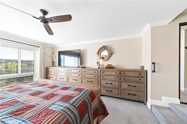 carpeted bedroom with crown molding and ceiling fan