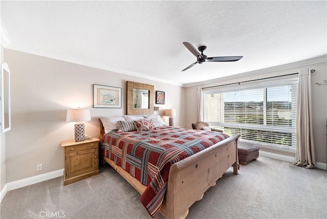 bedroom with crown molding, light carpet, ceiling fan, and a textured ceiling