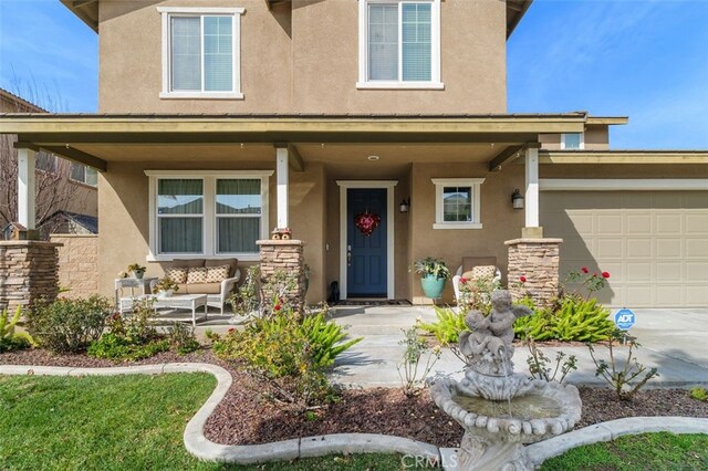 entrance to property with a garage and a porch