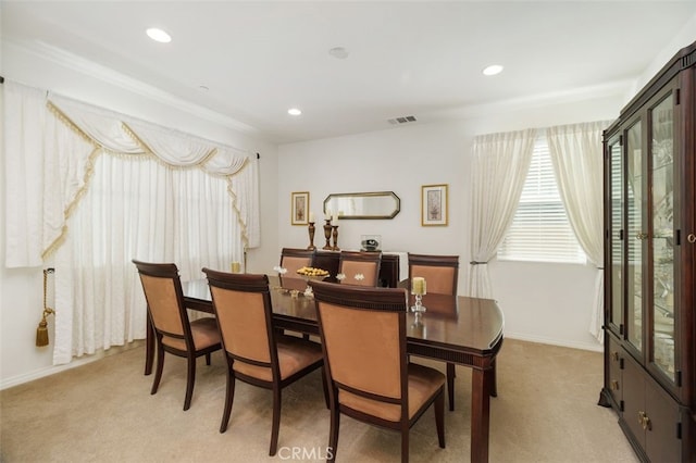 dining area featuring light carpet