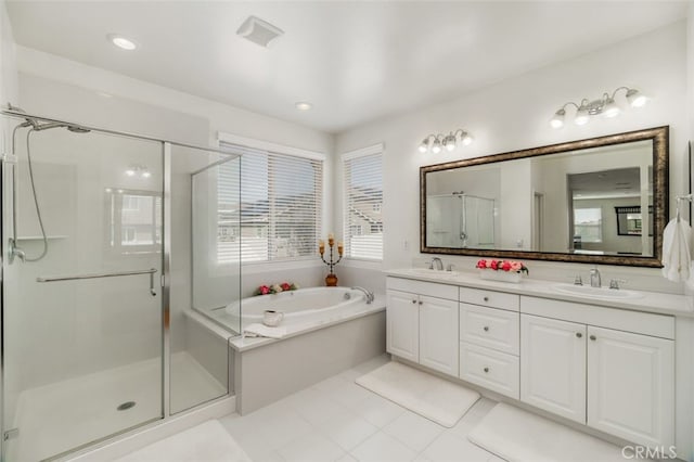 bathroom featuring tile patterned flooring, vanity, and separate shower and tub