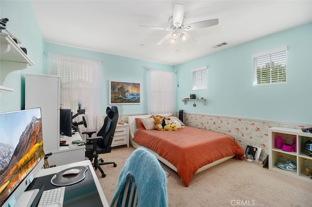 bedroom featuring light carpet and ceiling fan