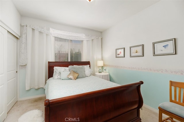 bedroom featuring light colored carpet and a closet