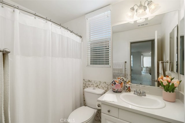 bathroom featuring vanity and toilet