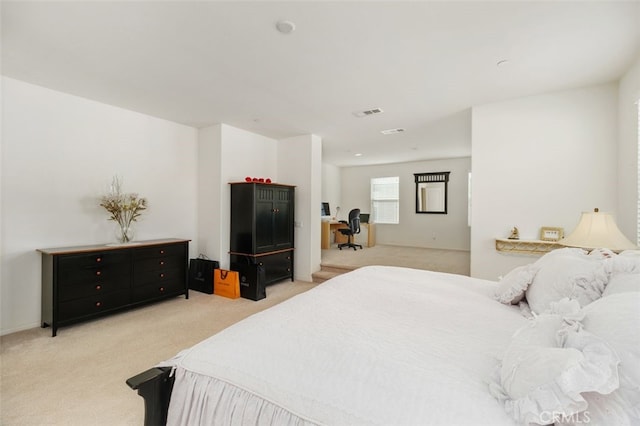 bedroom featuring light colored carpet