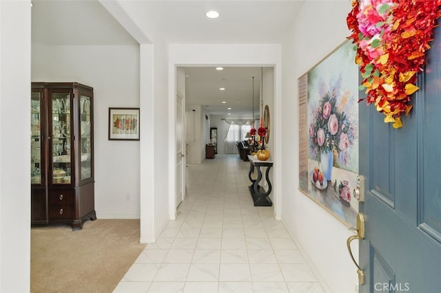 view of carpeted foyer entrance