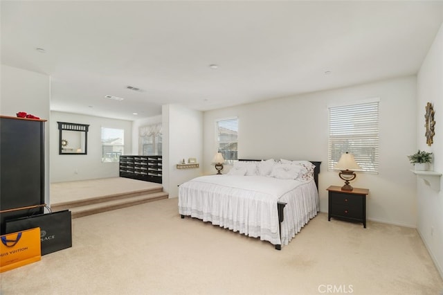 carpeted bedroom featuring multiple windows