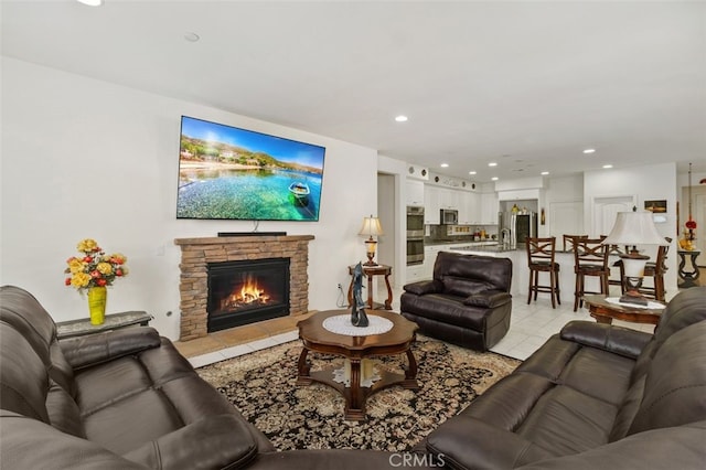 tiled living room with a stone fireplace