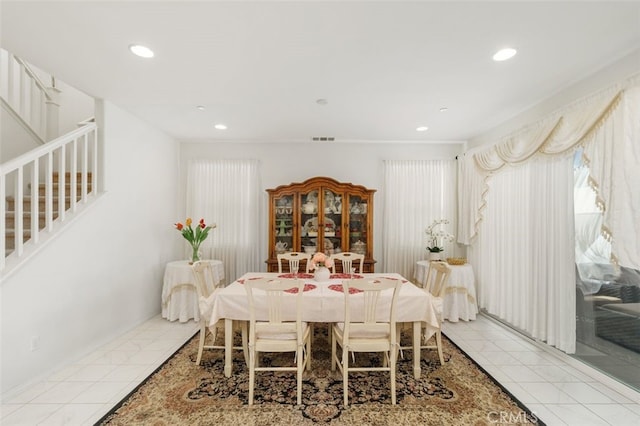 dining area featuring light tile patterned flooring