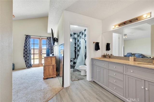 bathroom featuring vanity, hardwood / wood-style floors, toilet, and a textured ceiling