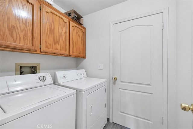 washroom featuring washer and dryer and cabinets