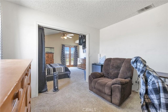 bedroom featuring light carpet, vaulted ceiling, french doors, and a textured ceiling