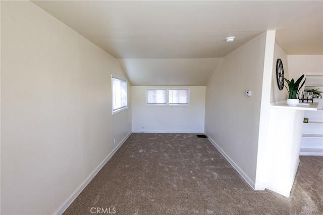 bonus room featuring carpet flooring and vaulted ceiling