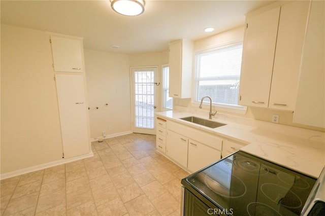 kitchen featuring white cabinetry, sink, and electric stove