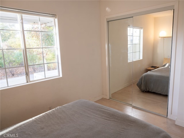 bedroom with multiple windows and a closet