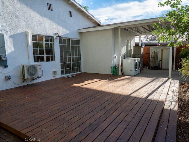 wooden terrace with separate washer and dryer and ac unit