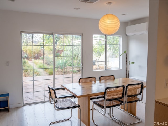 dining space featuring an AC wall unit