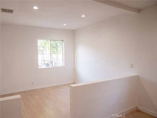 spare room featuring light hardwood / wood-style flooring