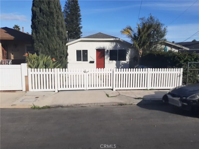 bungalow-style house featuring a fenced front yard