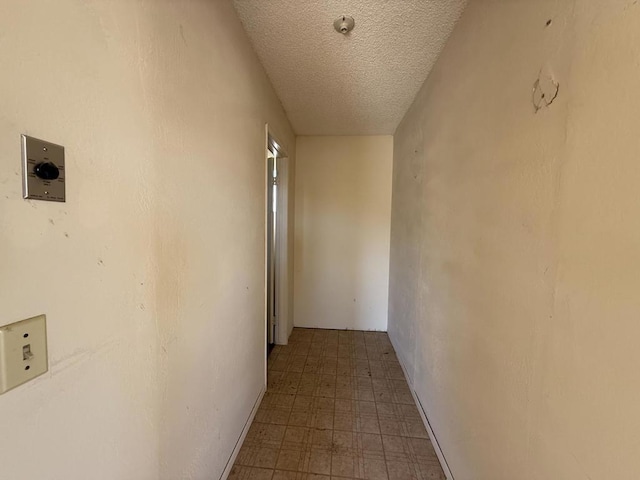 hallway with a textured ceiling