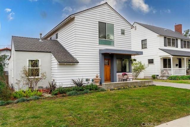 view of front of house with a front lawn and covered porch