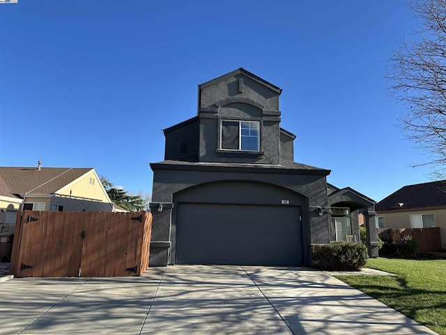 view of front of house featuring a garage and a front lawn