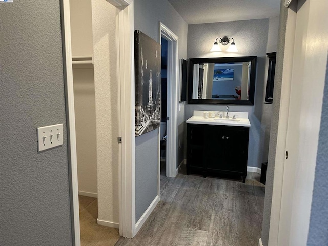 hall featuring sink and dark wood-type flooring