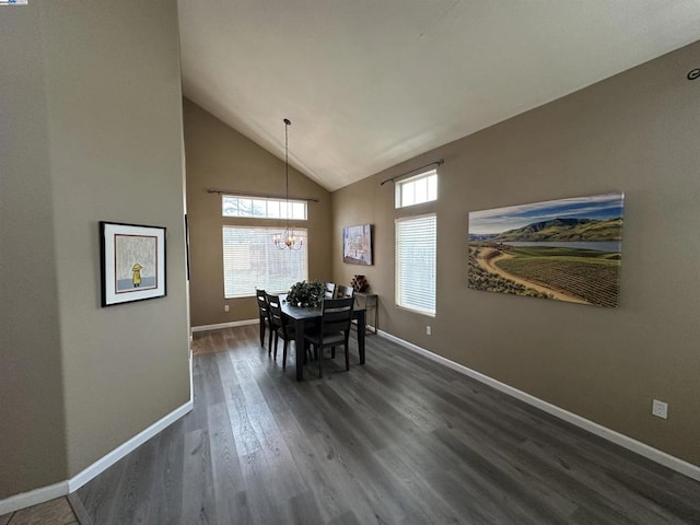 dining space with dark hardwood / wood-style floors, a chandelier, and high vaulted ceiling