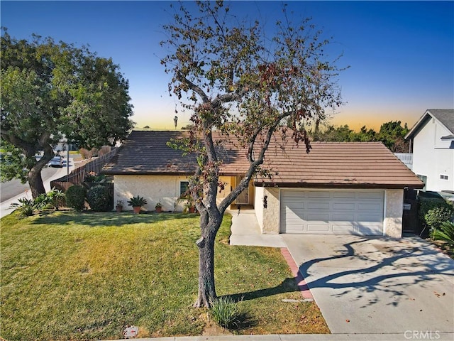 view of front of property with a yard and a garage