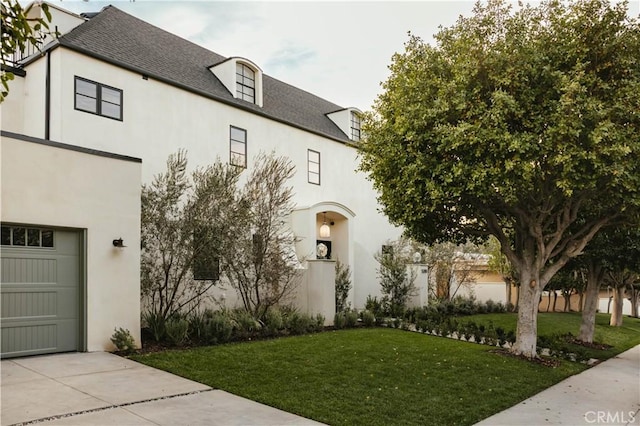 view of front of house with a garage and a front yard