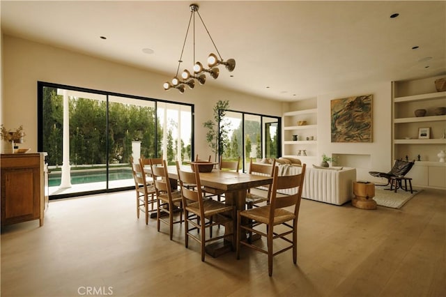 dining space featuring built in features and light hardwood / wood-style floors