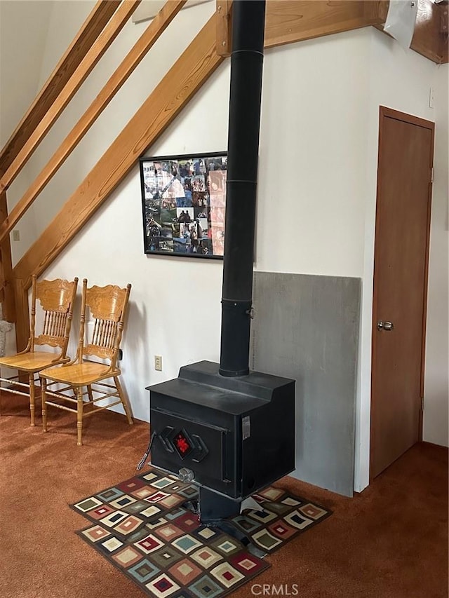 room details featuring carpet flooring and a wood stove