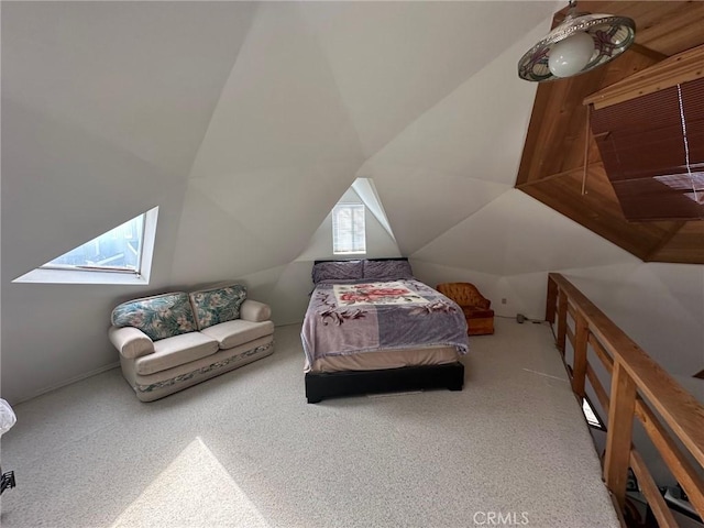 carpeted bedroom featuring lofted ceiling with skylight