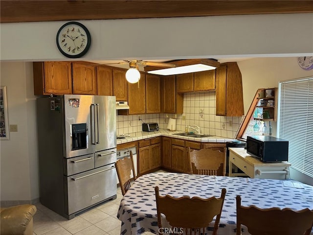 kitchen featuring sink, tile countertops, high quality fridge, wall oven, and backsplash