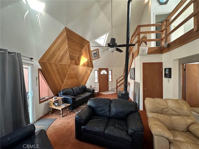 living room with ceiling fan, carpet, and a high ceiling