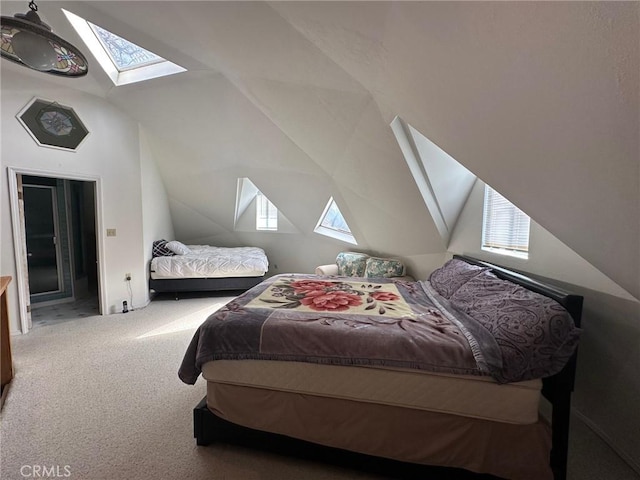 carpeted bedroom with lofted ceiling with skylight